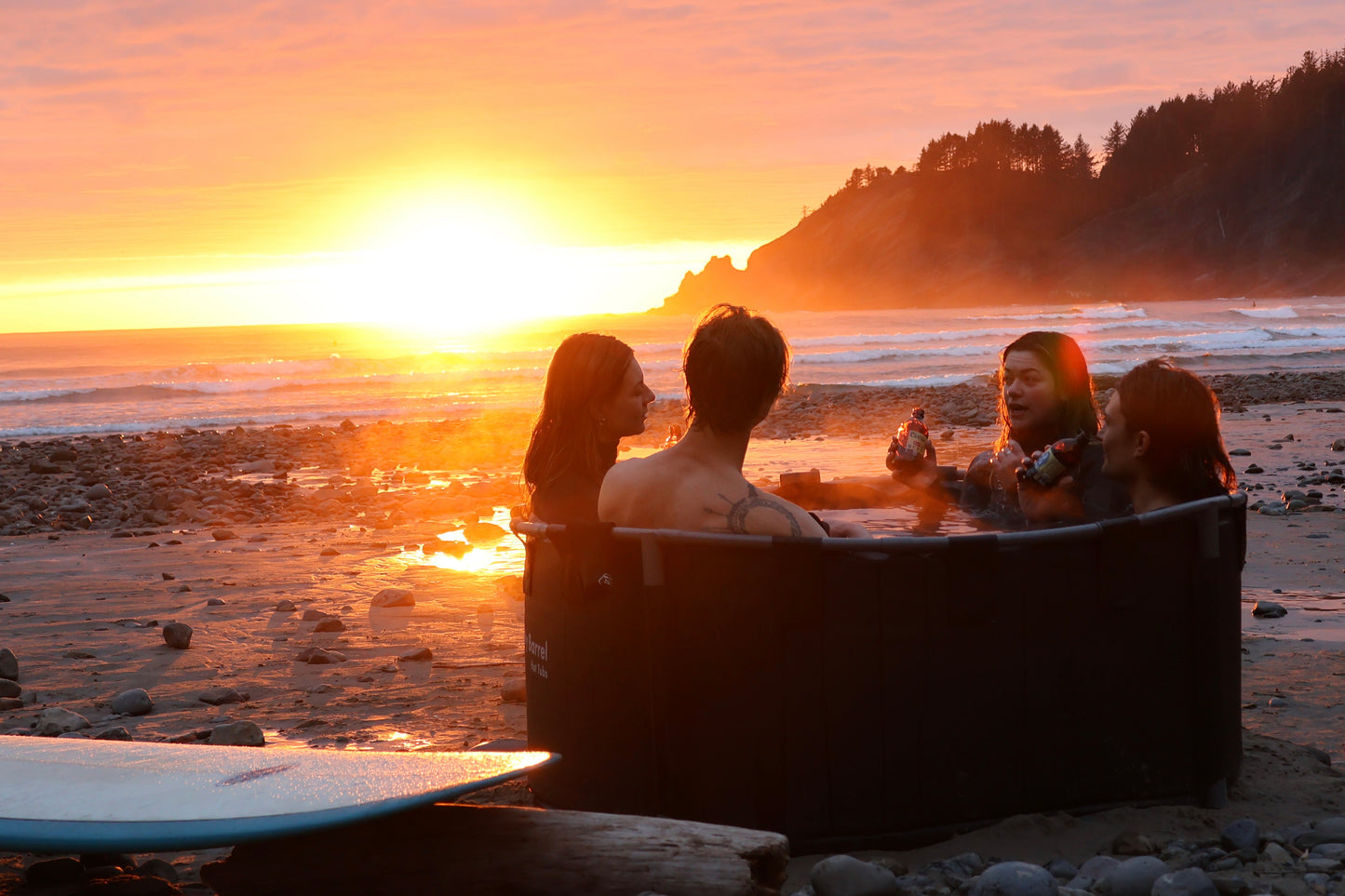 Steamy portable wood fired hot tub at sunset 