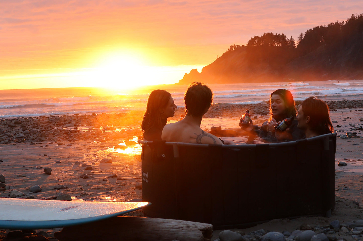 Steamy portable wood fired hot tub at sunset